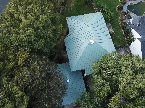 Top-down aerial showing full metal roof layout